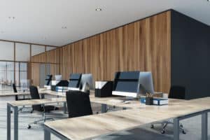 Environmental style open space office interior with a concrete floor, wooden walls and computer tables. 3d rendering mock up